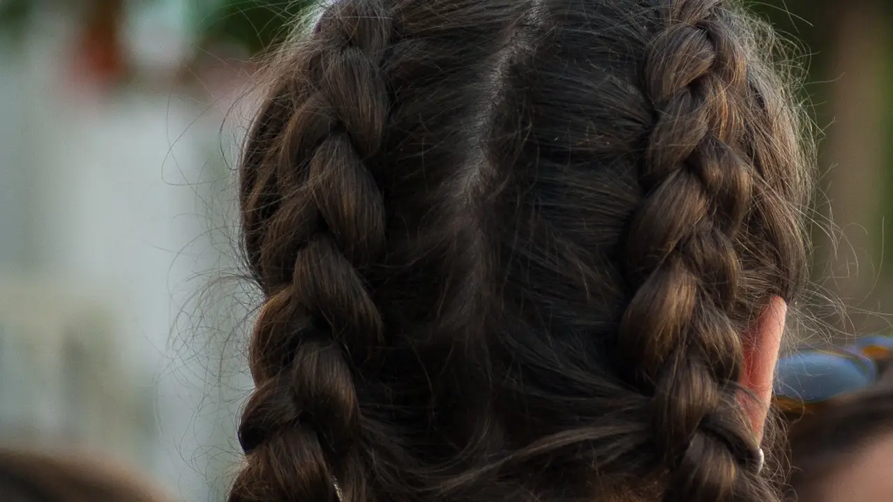 Two mint chocolate milkshakes with whipped cream and green sprinkles.