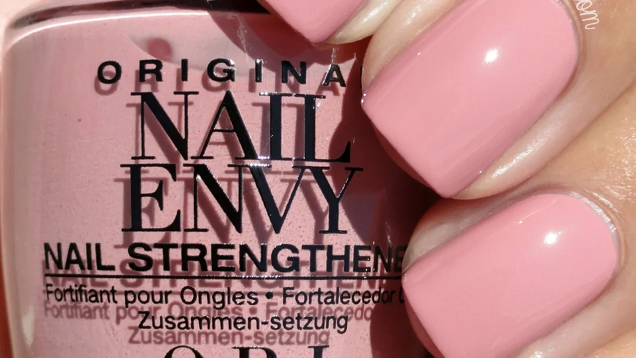 blue bowl of black bean beef tortilla soup on a board with cilantro and shredded cheese in background