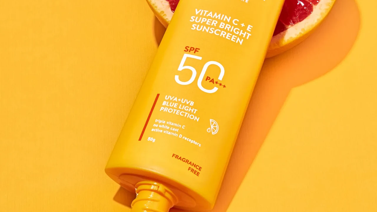 blue bowl of black bean beef tortilla soup on a board with cilantro and shredded cheese in background